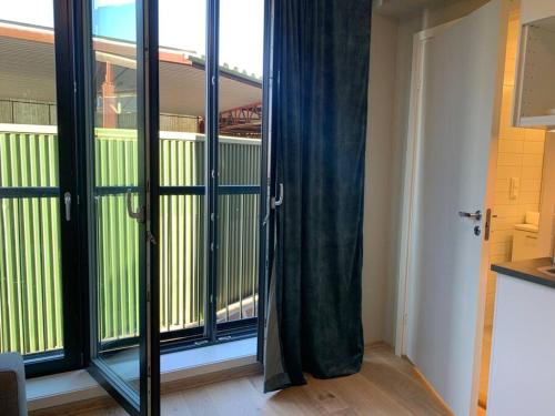 a room with sliding glass doors with a balcony at Central 1 bedroom apartment NB!! Small room in Oslo