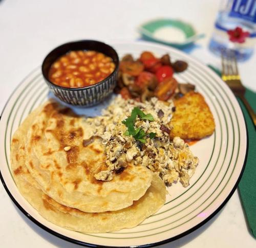 a plate of food with pancakes and a bowl of beans at The Parr’s Bank Hotel in Warrington