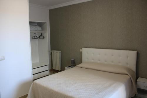 a bedroom with a white bed and a mirror at Ce sta 'o mar for in Naples