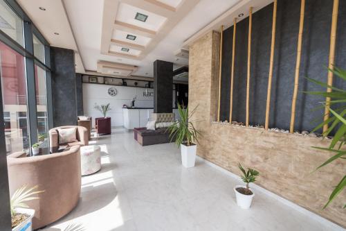 a lobby with potted plants in a building at Polina Beach in Sozopol