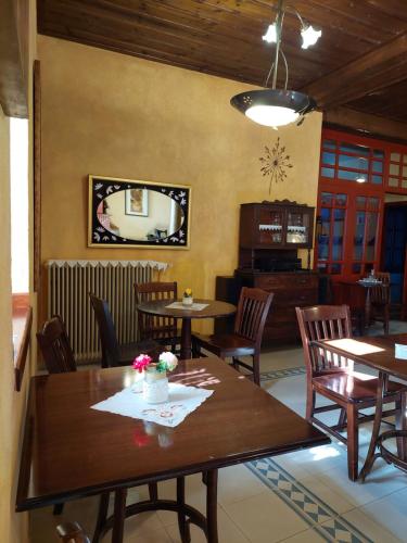 a dining room with wooden tables and chairs at House Mitsiou Traditional Inn in Arnaia