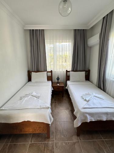 a bedroom with two beds and a window at Villa Misli - Heart of Dalyan and Newly Renovated in Dalyan