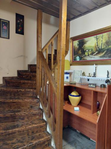 a staircase in a house with a wooden stair case at House Mitsiou Traditional Inn in Arnaia