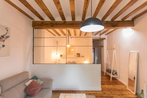 a living room with a couch and a large window at DuermeCuenca in Cuenca