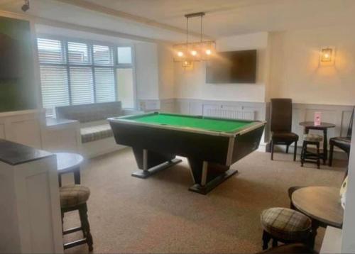 a living room with a pool table in it at The Graph’s Gaff 