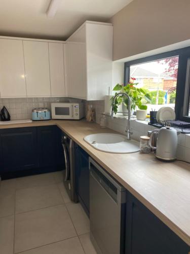 a kitchen counter with a sink and a window at Daria in Pedmore
