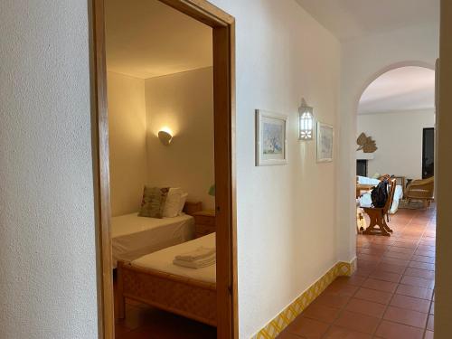 a mirror in a room with a bed and a bedroom at Beach House Golden Club in Cabanas de Tavira