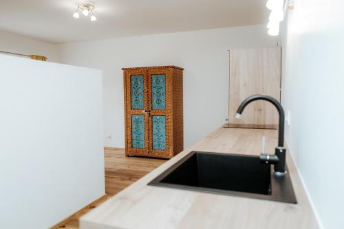 a kitchen with a sink and a wooden door at AuerHias in St. Wolfgang