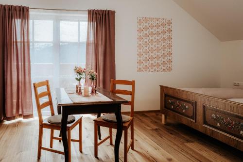 a bedroom with a table and chairs and a bed at AuerHias in St. Wolfgang