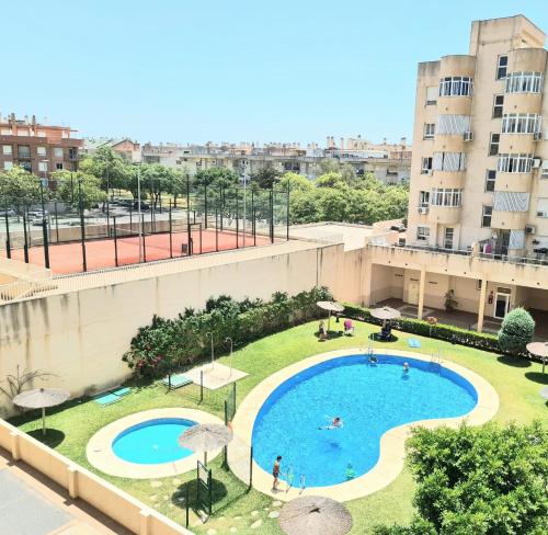 an overhead view of a swimming pool in a city at Apartamento 3 dormitorios Malaga (Teatinos) in Málaga