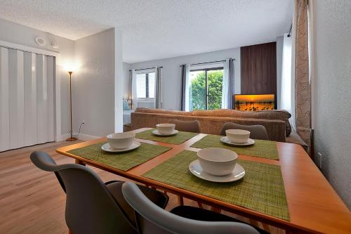 a living room with a table and chairs and a couch at Cozy Condo on International Dr. Near Universal Studios in Orlando
