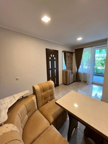 a living room with a couch and a table at Green Park Guest House in Dilijan