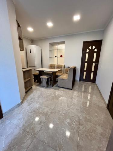 a living room with a table and a kitchen at Green Park Guest House in Dilijan