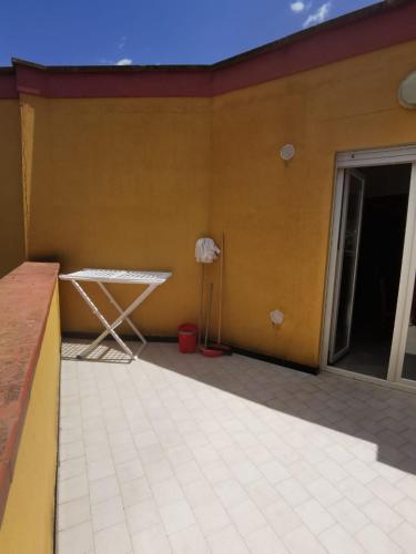 a patio with a table on the side of a house at Cala San Giorgio Residence in Sciacca