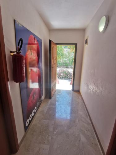a hallway with a door and a painting on the wall at Cala San Giorgio Residence in Sciacca