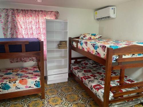a small bedroom with two bunk beds and a bed at Casa Cairo in Cartagena de Indias