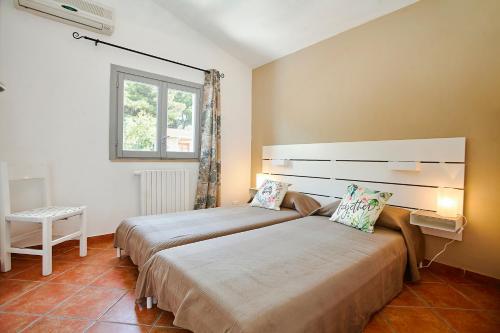 a bedroom with two beds and a window at Villa Antonella - Pool and Sea view in Castellammare del Golfo