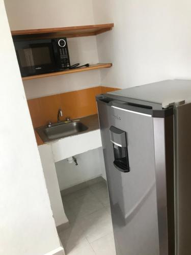 a small kitchen with a stainless steel refrigerator and a sink at Casa Caracol Guanajuato in Guanajuato