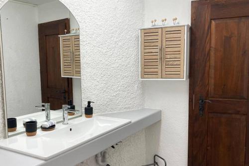 a bathroom with a sink and a mirror at Gite des Pavés à Peseux in Neuchâtel