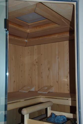 a sauna with wooden walls and a bench in it at Oase zum SEIN in Spiez