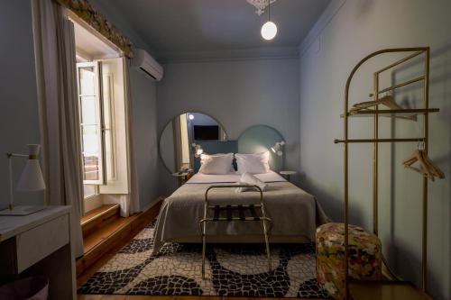 a bedroom with a bed and a large mirror at LR Guest House in Lisbon