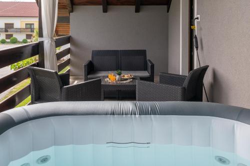 a patio with a table and chairs and a pool at Deluxe Apartment with Jacuzzi - PATAR in Rakovica