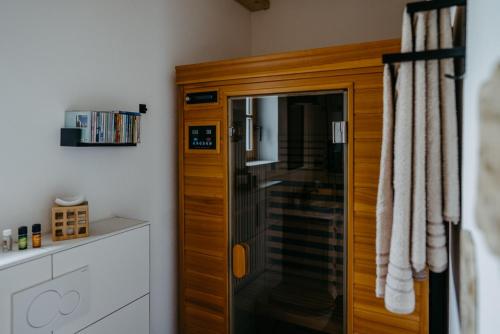 a bathroom with a shower with a wooden cabinet at Weinberg Chalet Kokumandl in Winten