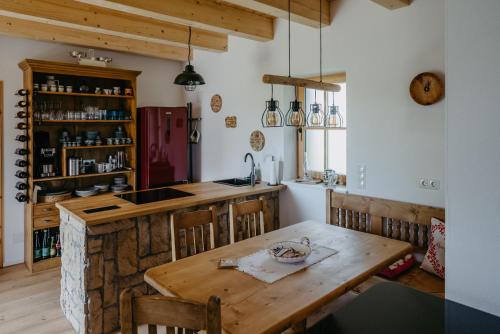 a kitchen with a wooden table and a counter at Weinberg Chalet Kokumandl in Winten