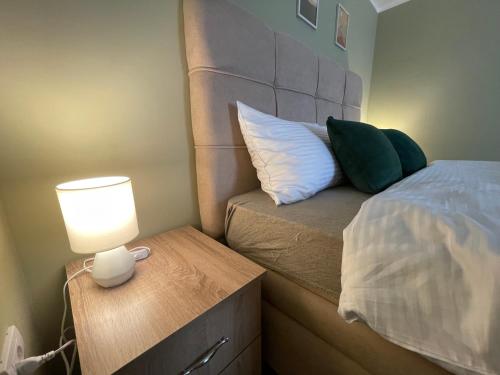 a bedroom with a bed and a lamp on a night stand at Duplex Oasis Ada in Ada