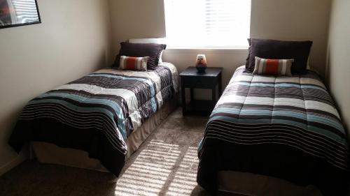 two beds sitting next to each other in a room at Cedar Canyon Condos in Blanding