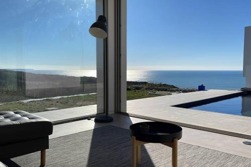 a living room with a view of the ocean at Amazing Sea View Beach House in Lourinhã