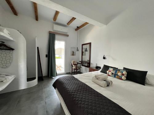 a bedroom with a large bed and a sink at Akti Kastraki Beach in Kastraki Naxou