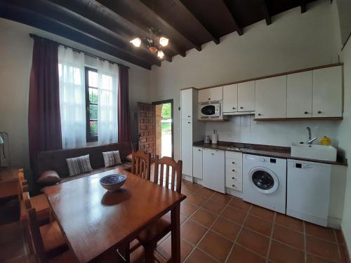 a kitchen and dining room with a table and a dining room at La Casa Solariega in Santillana del Mar