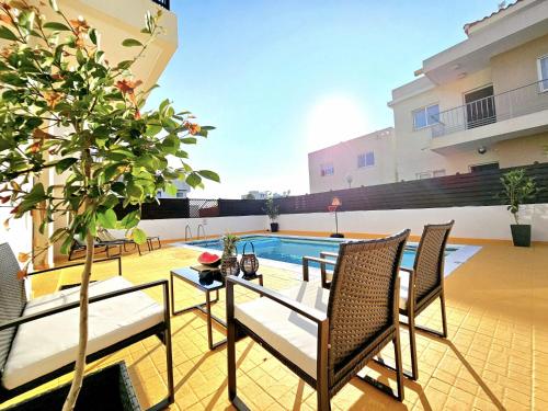 a patio with a table and chairs and a pool at Spacious Villa with Private Pool in Paphos City