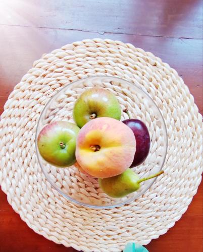a basket of apples and other fruit on a table at Loreto LYA SEA VIEW APARTMENTS in Rovinj
