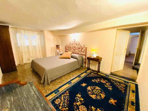 a bedroom with a bed and a blue rug at Nel cuore di Genova in Genova