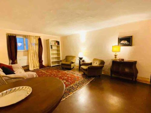 a living room with a couch and chairs and a table at Nel cuore di Genova in Genova
