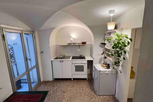a small kitchen with a sink and a refrigerator at Nel cuore di Genova in Genova