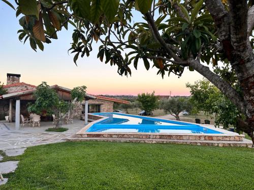 a swimming pool in a yard next to a house at Quinta do Nobre in Marialva