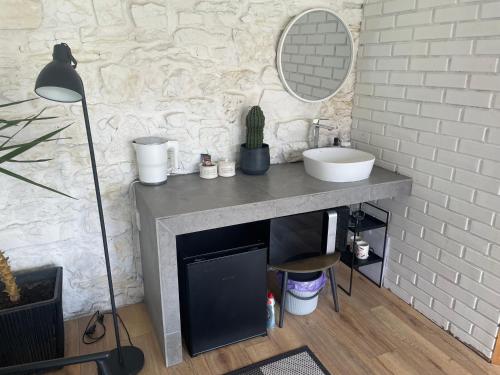 a bathroom with a sink and a mirror at Tatsopus in Kamianets-Podilskyi