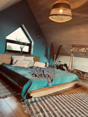 a bedroom with a large bed in a room at Domek Ostoja Góry Sowie in Łomnica