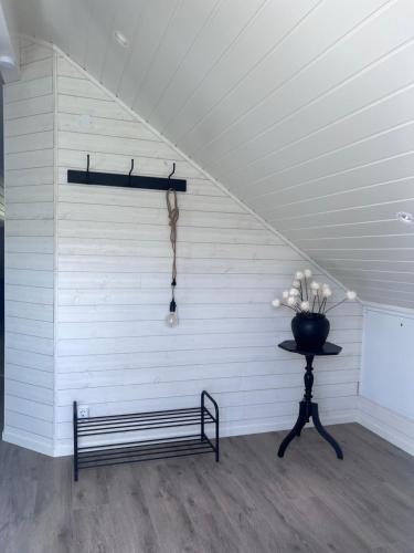 a bench in a room with a white wall at Medvik Högalid in Strömstad
