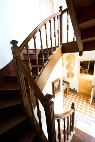a wooden staircase in a house with a room at La ferme de Roquedure in Montfaucon