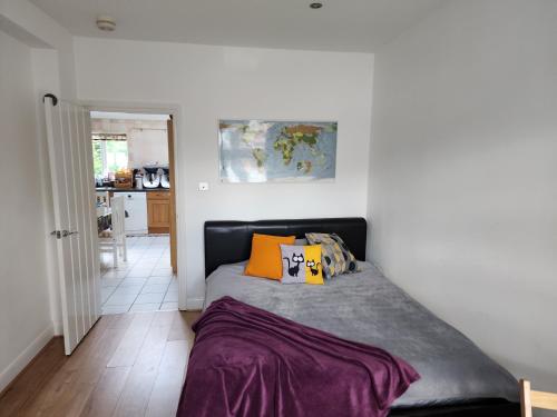 a bedroom with a bed with two pillows on it at Countryside Home in London in Shirley