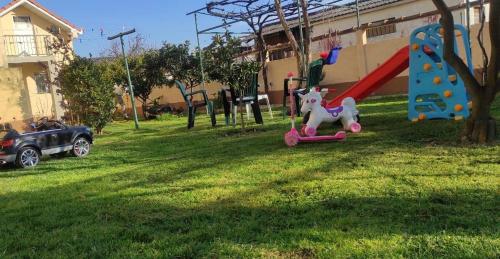 a playground with a toy horse on a scooter in a yard at Mič house in Bar