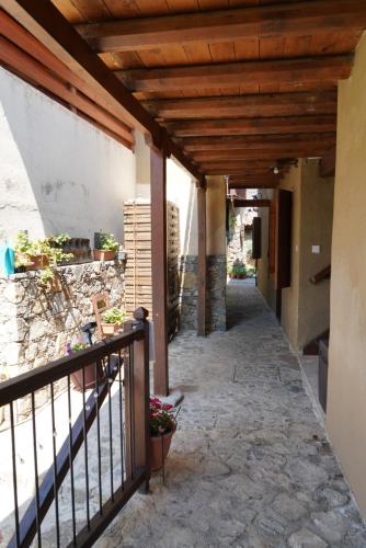 a balcony of a house with a wooden ceiling at Morfeas Kakopetria in Kakopetria