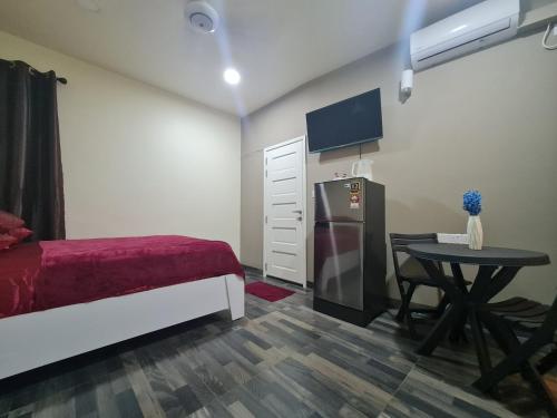 a bedroom with a bed and a table and a refrigerator at Resting View in Male City
