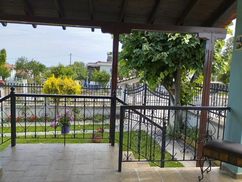a balcony with a gate and a garden at Amadrias by the sea in Vergia