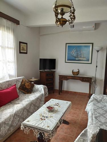 a living room with a couch and a table at Amadrias by the sea in Vergia