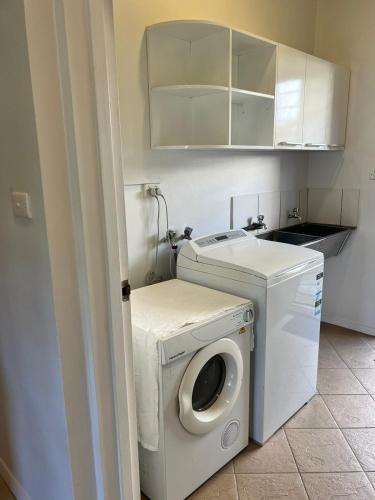 a white washer and dryer in a small room at Garden Apartments in Nadi